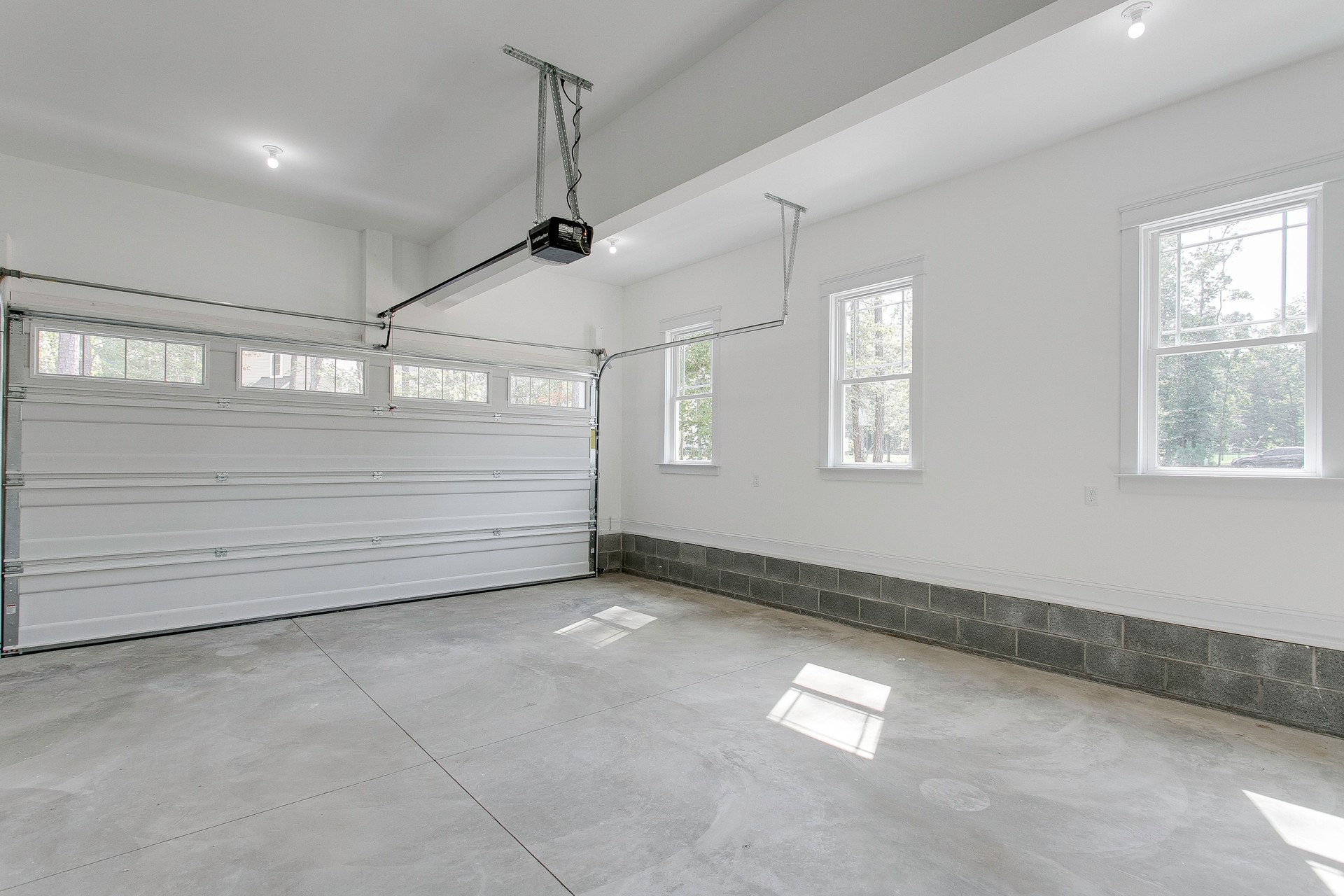 Bright Garage Space With Dual Overhead Doors Open.
